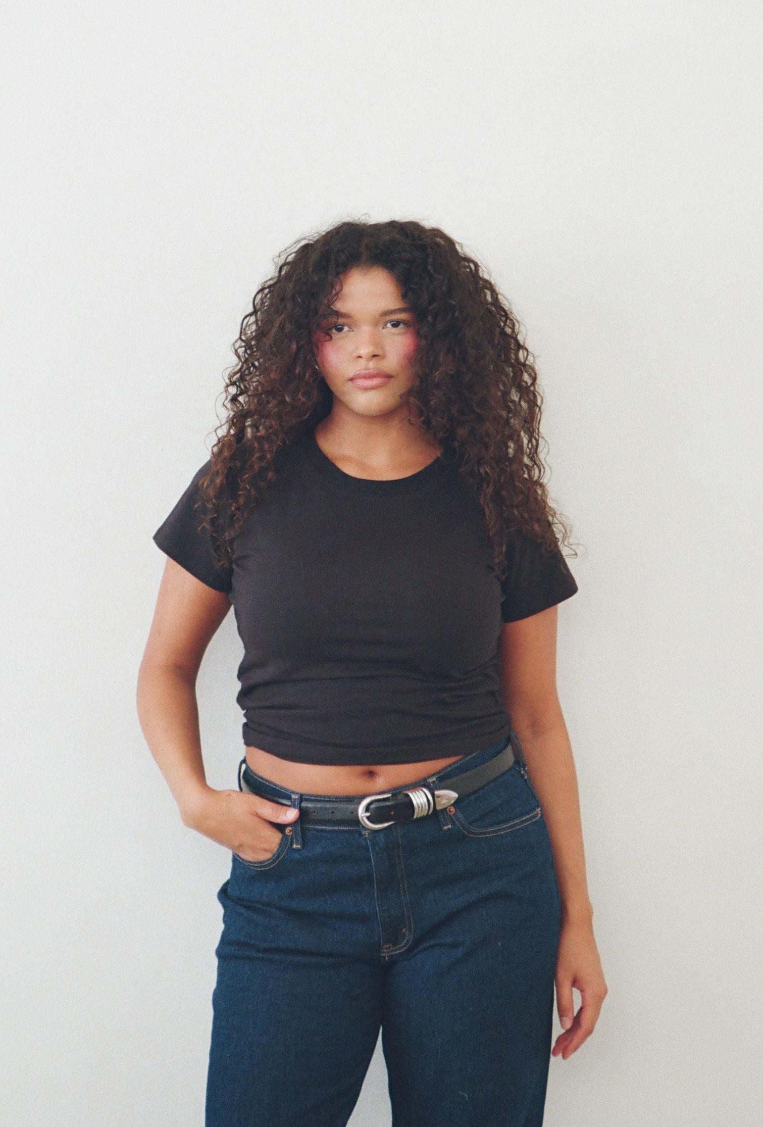 Black crew neck tee styled with dark denim