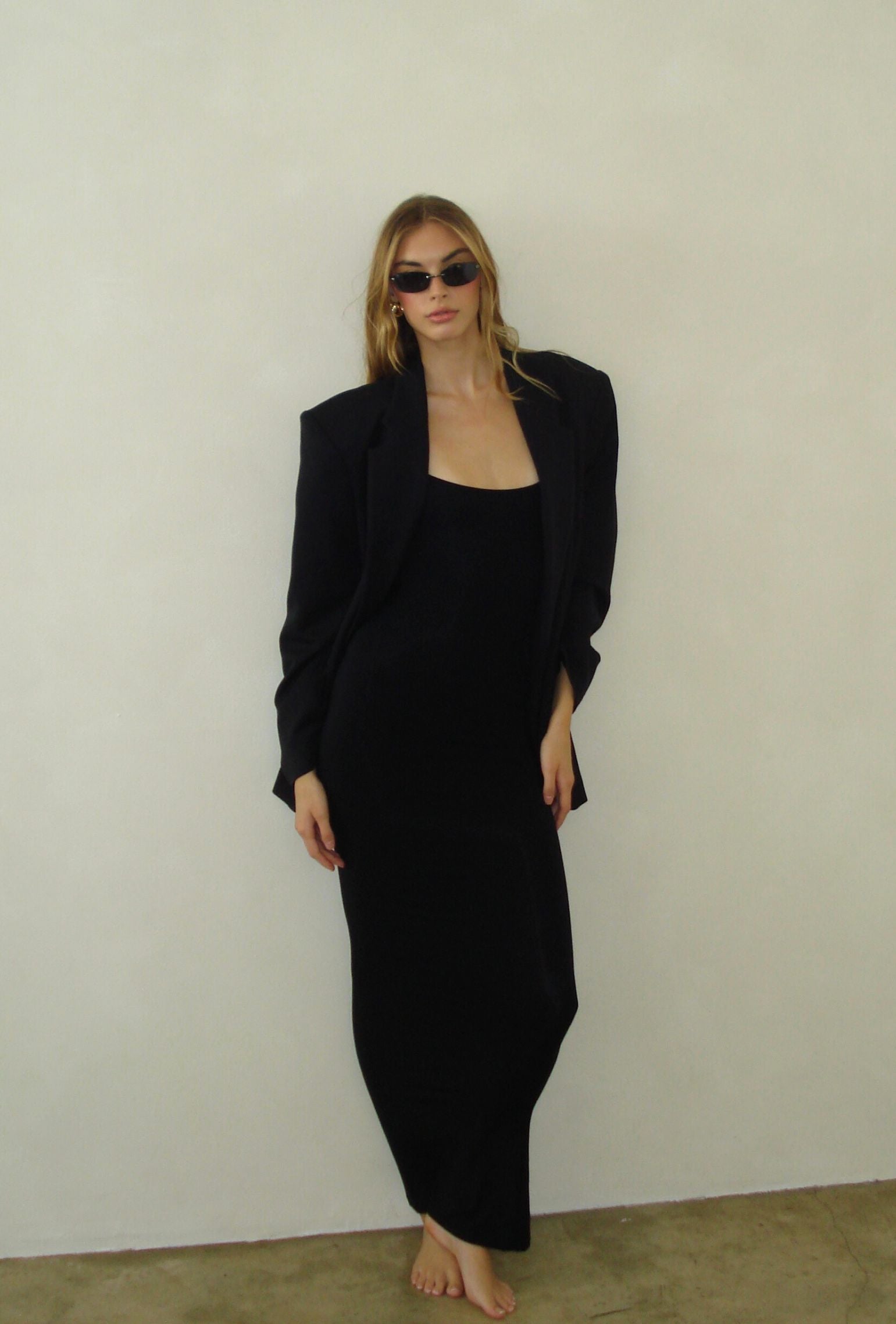 Black minimalist maxi dress styled with an oversized black blazer