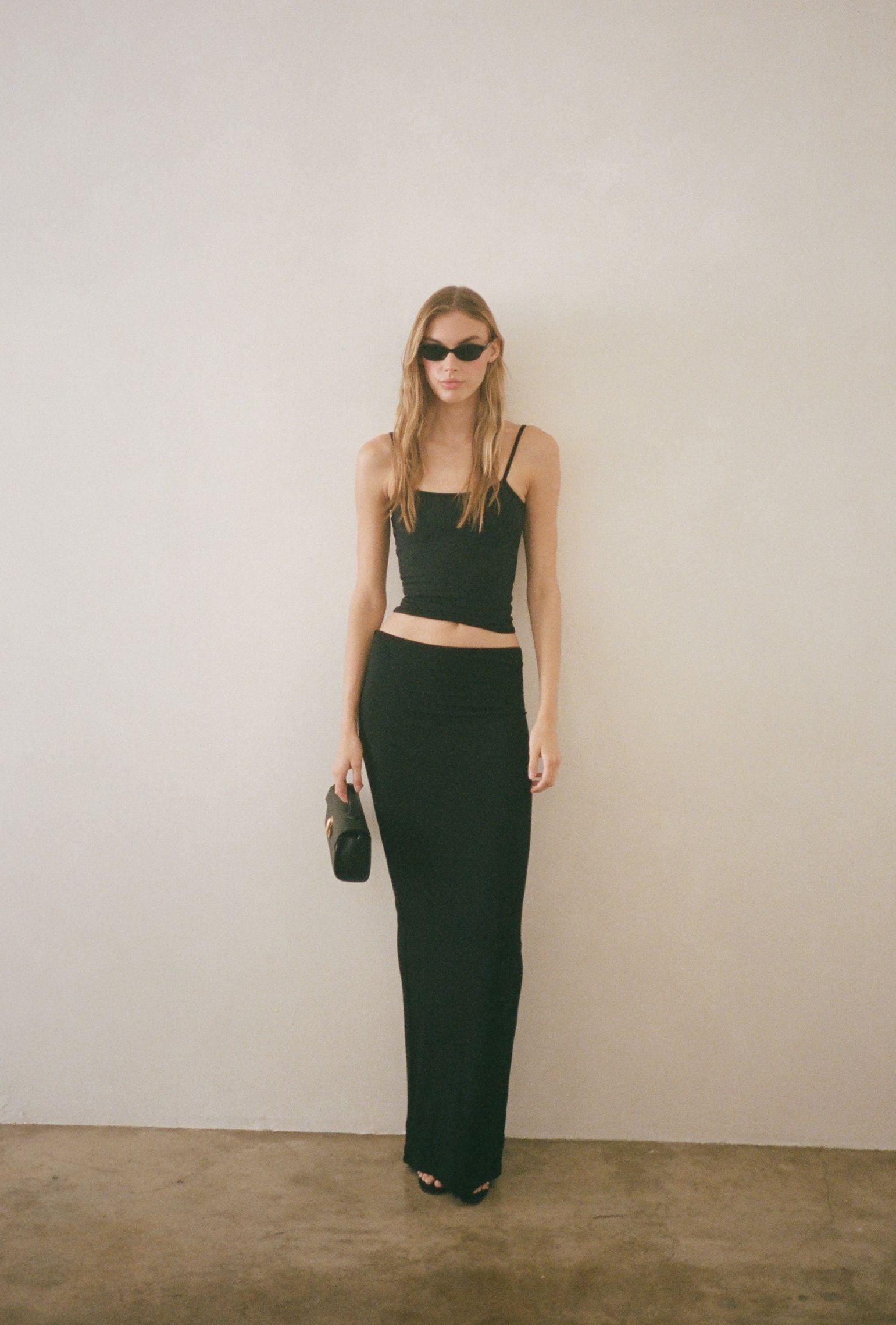 Black low-waisted maxi skirt styled for an evening look