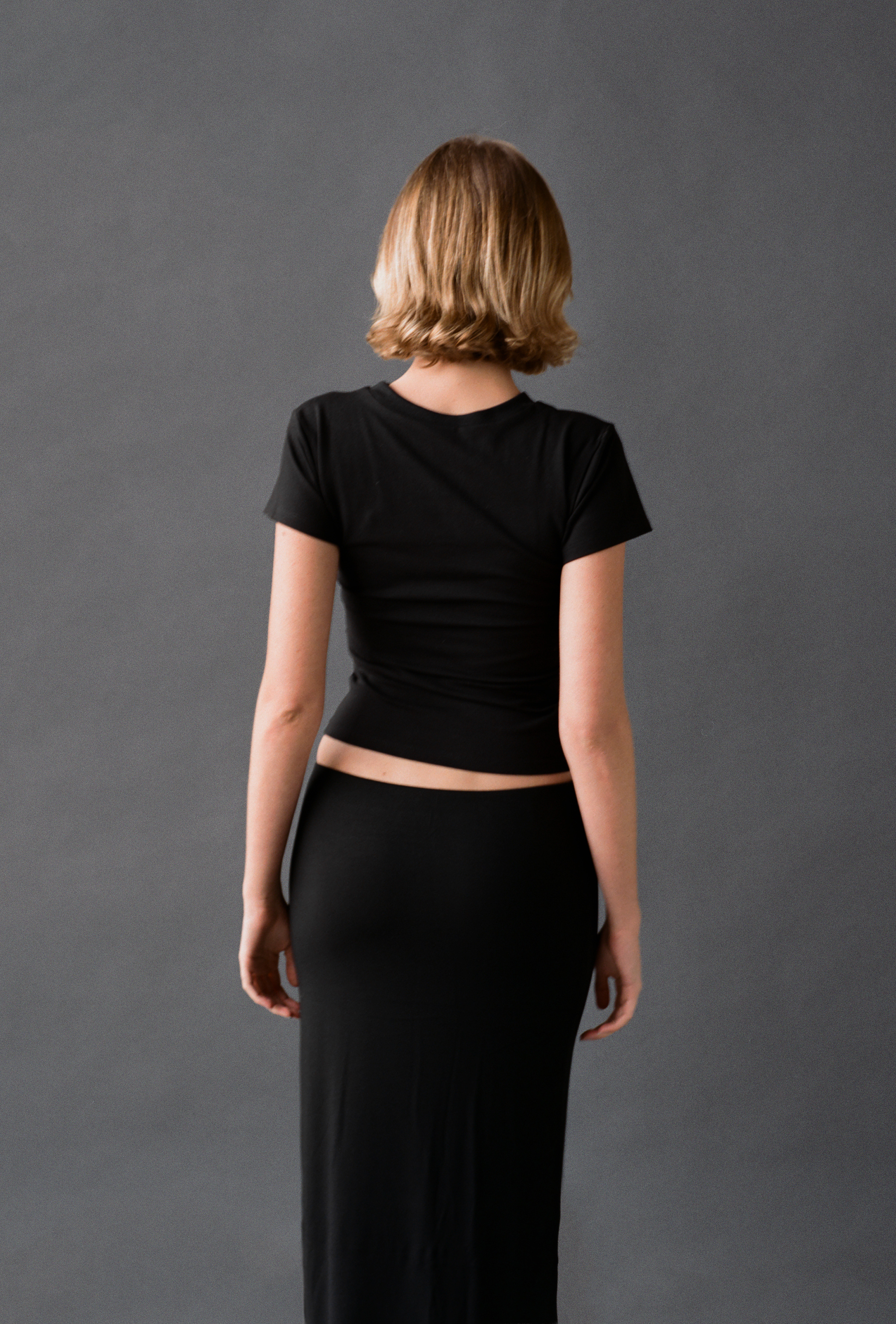 LAUD tee in black, back view styled with maxi skirt