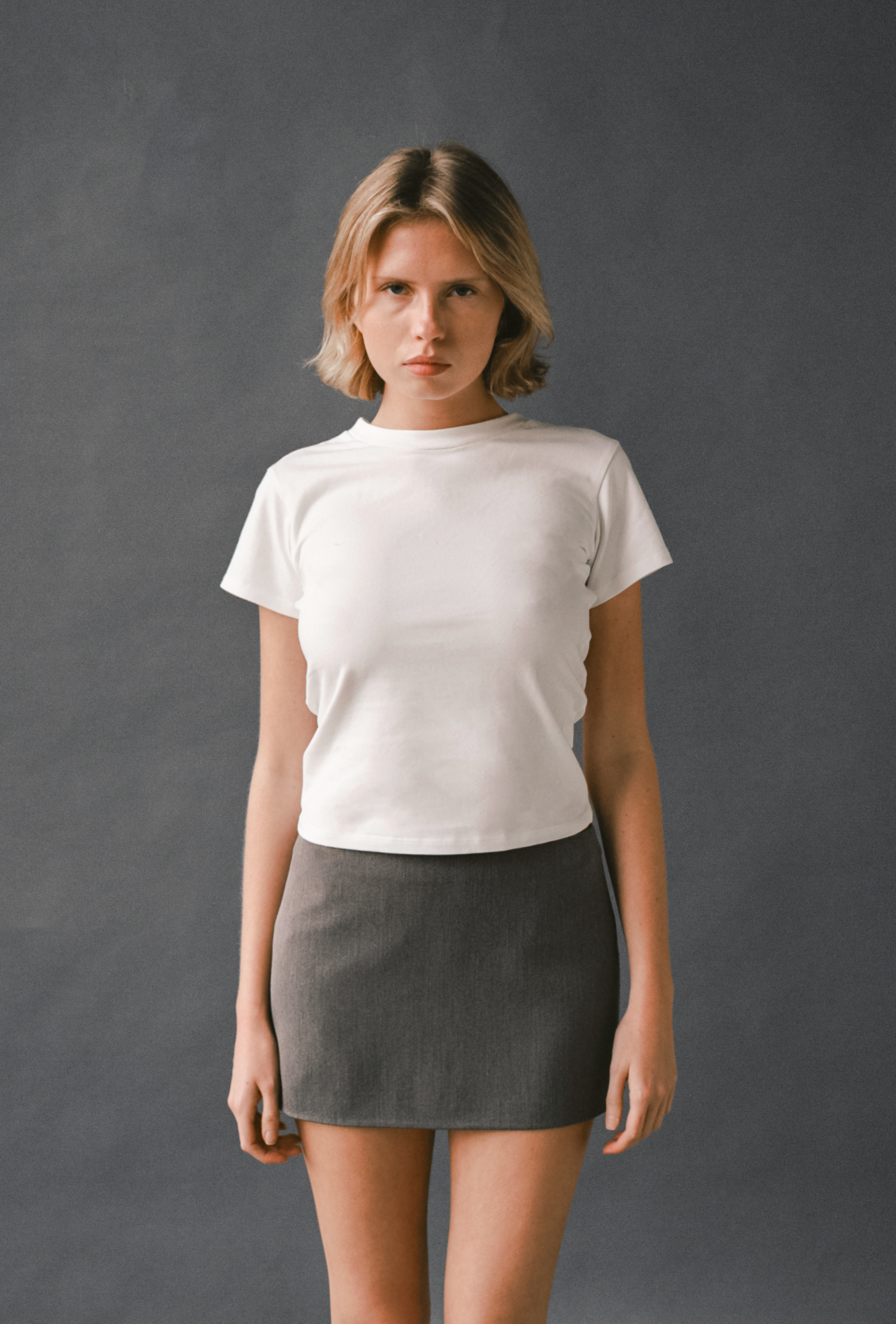 Front view of the LAUD tee in white styled with the mini skirt