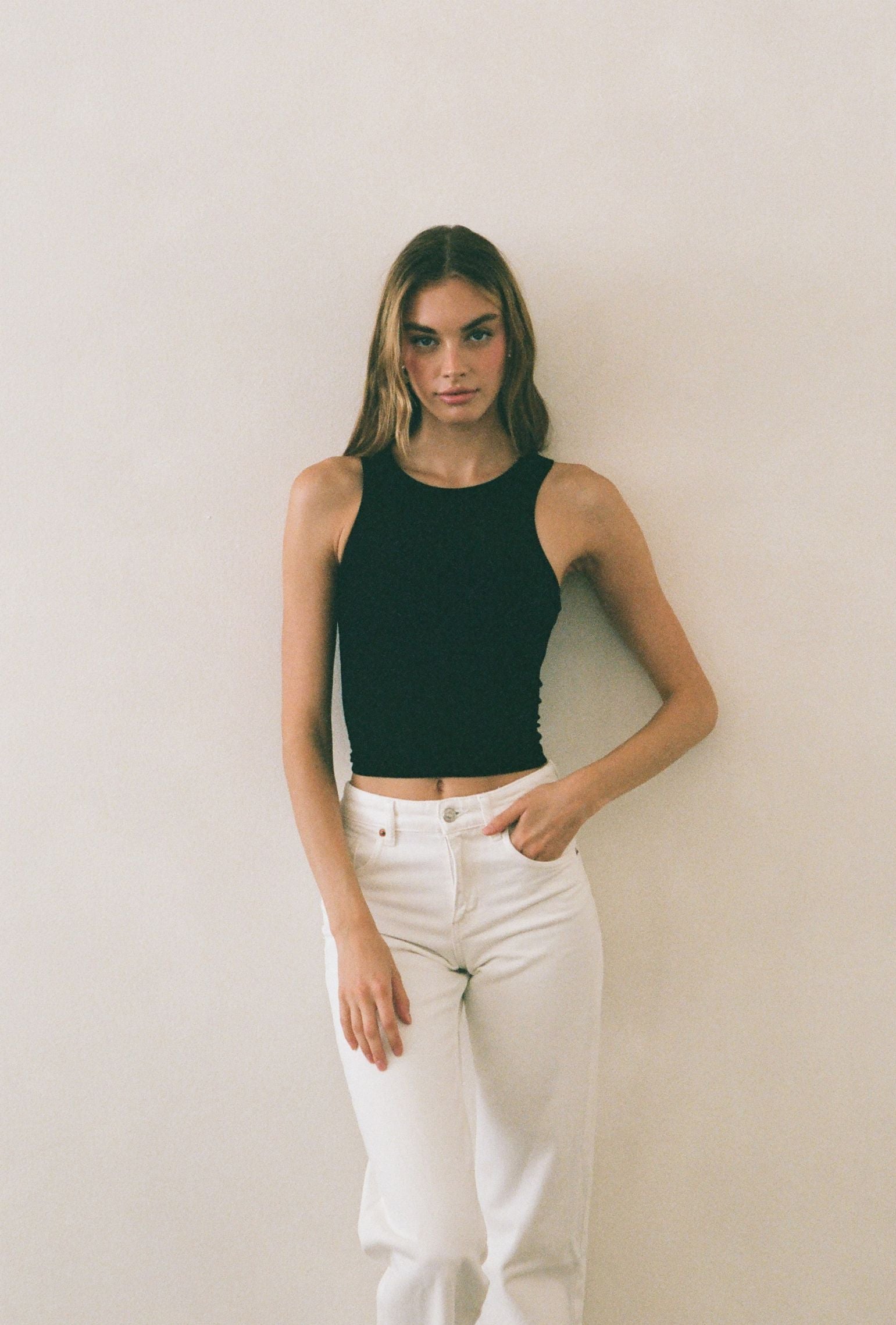 Black cropped high neck tank styled with white denim