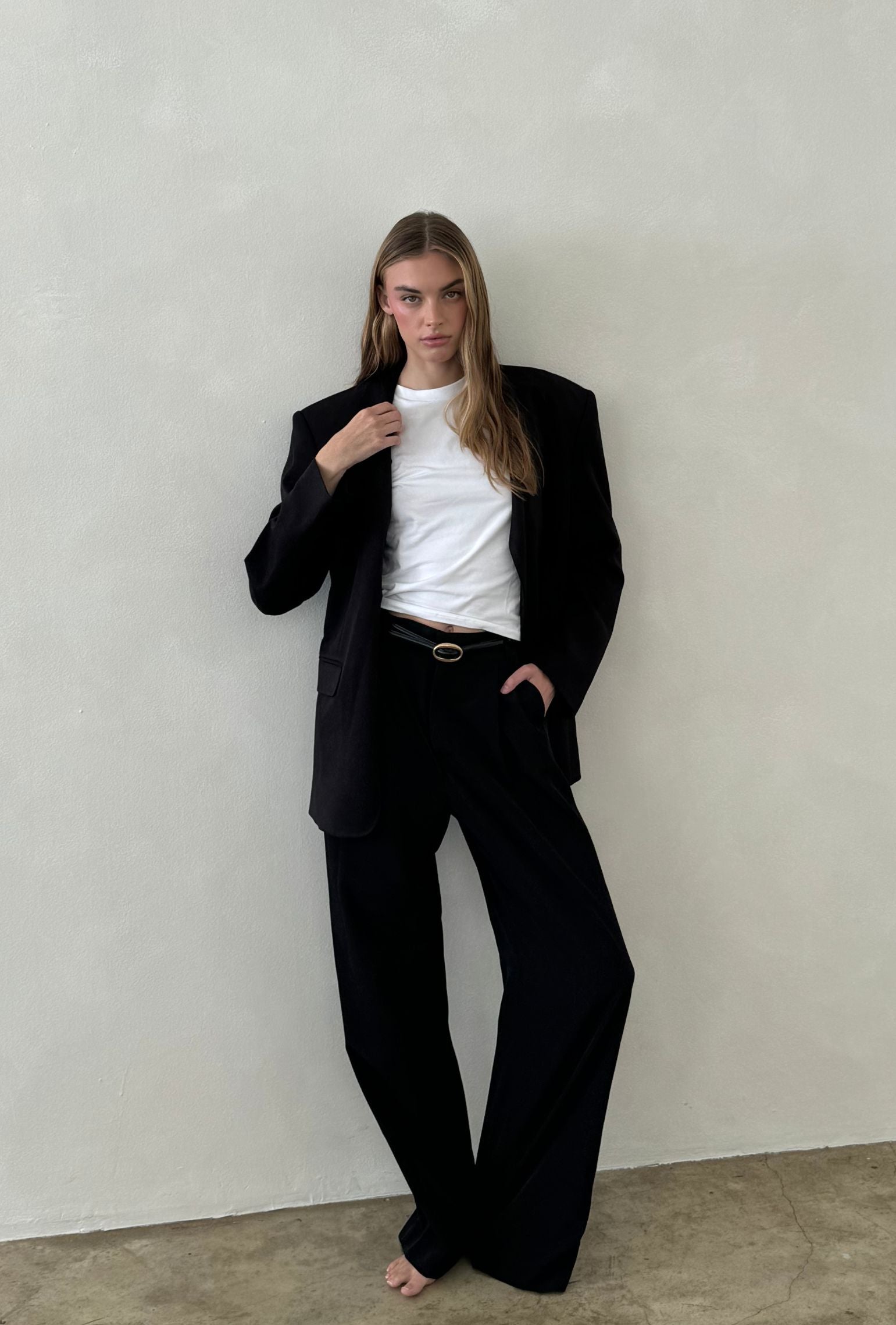 Black oversized blazer styled with a white crew neck tee and wide leg trousers