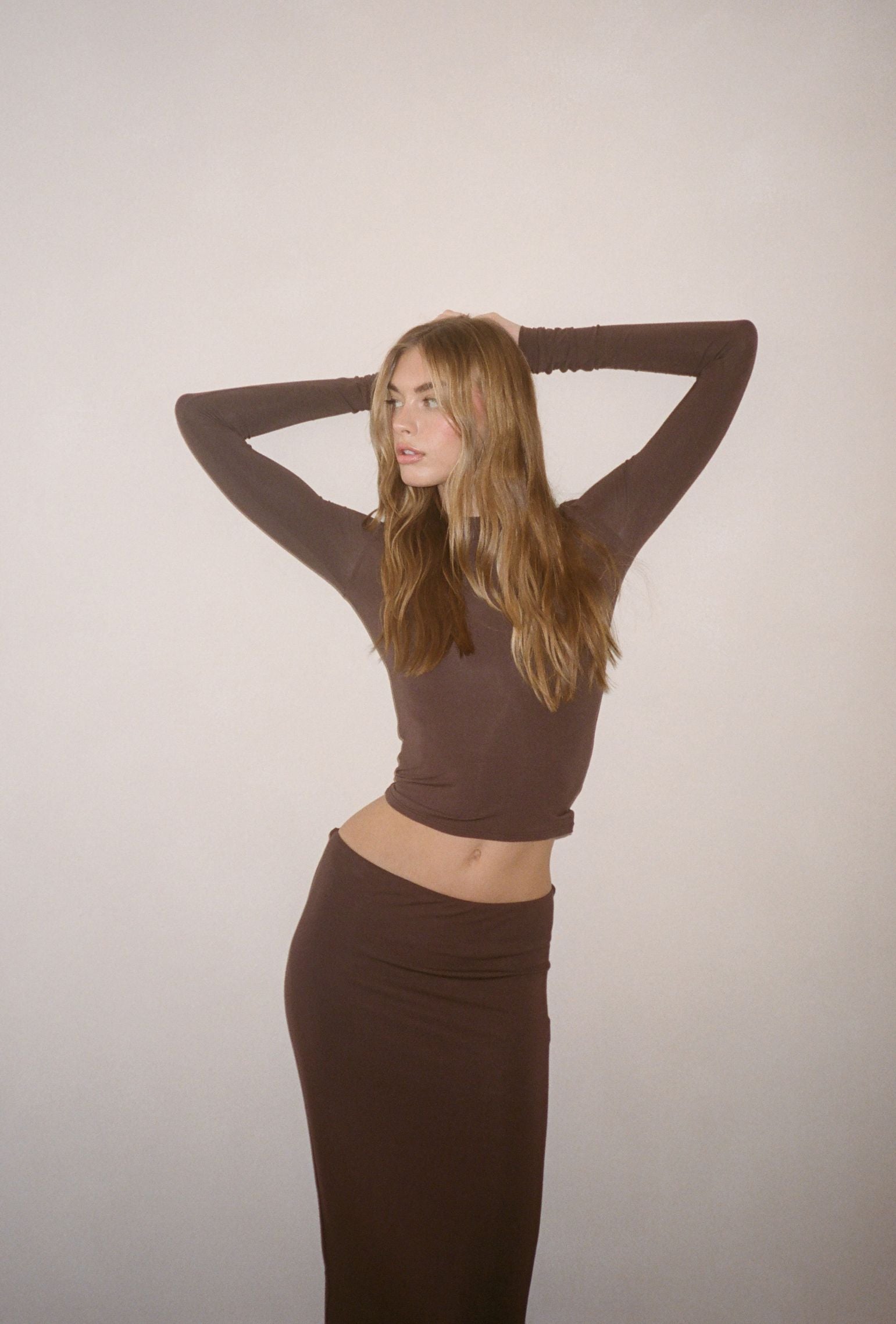 Brown low-waisted maxi skirt styled with a matching long sleeve
