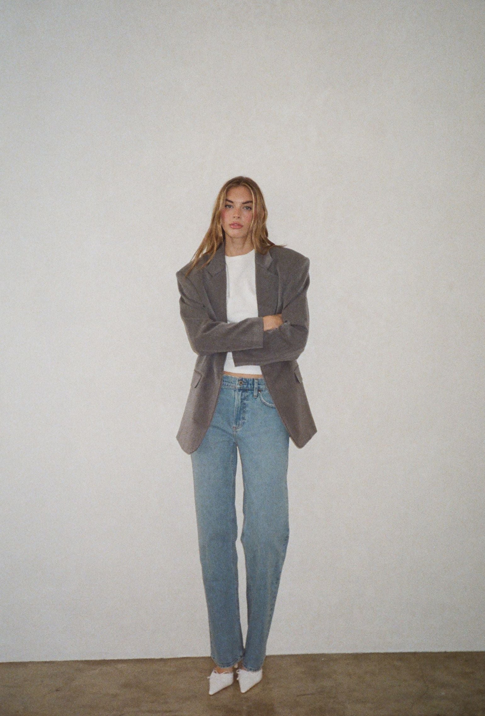 Gray oversized blazer styled with a white crew neck tee and straight leg denim