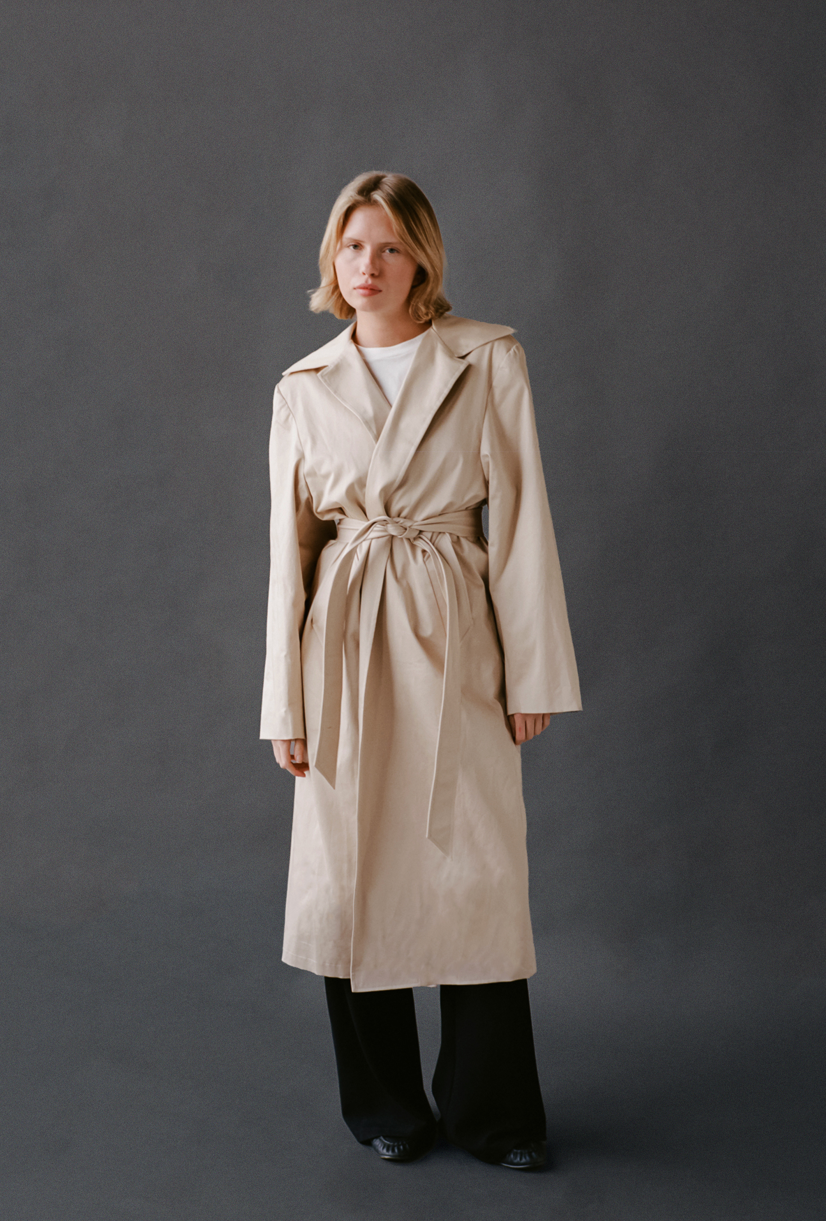LAUD trench coat tied closed with white tee and black pants