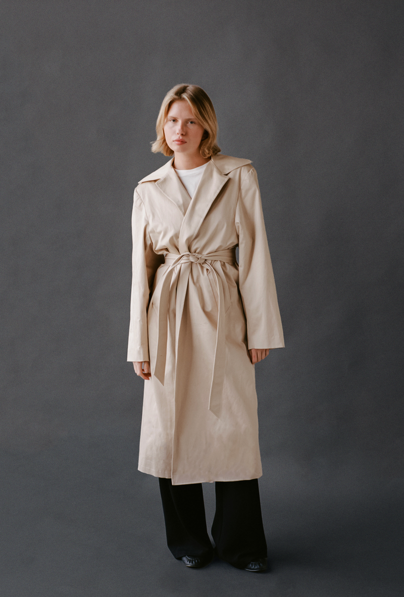 LAUD trench coat tied closed with white tee and black pants