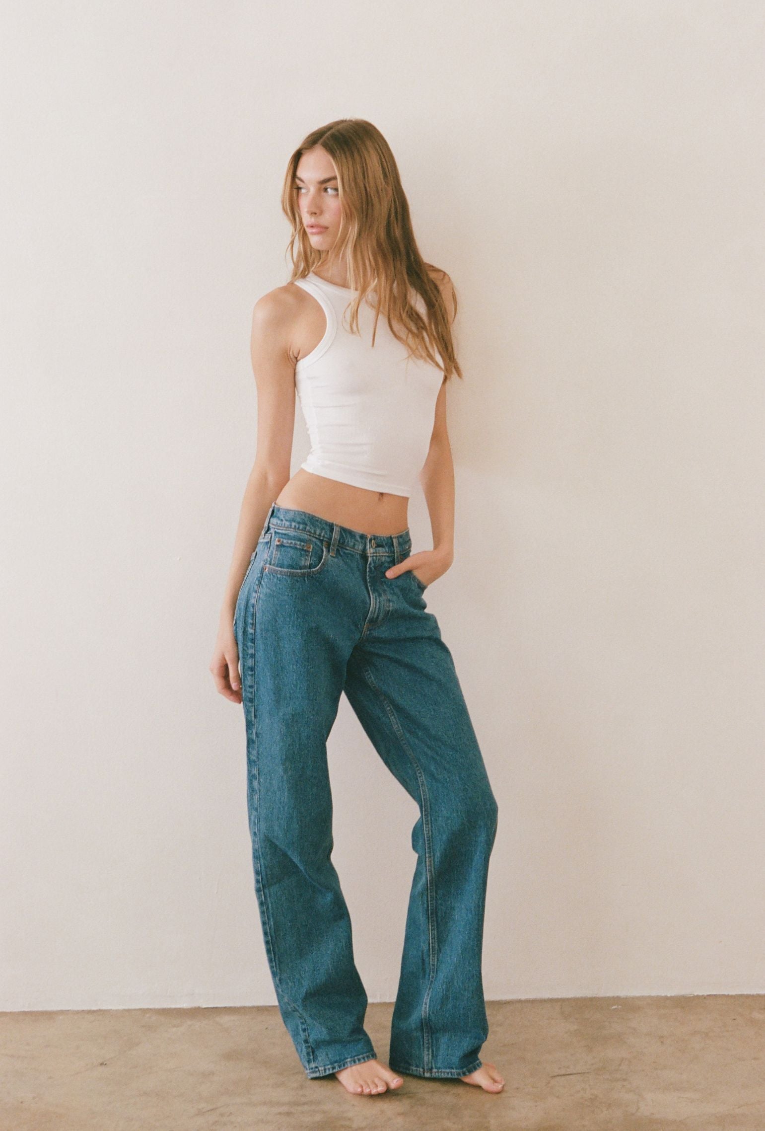 White cropped high neck tank styled with denim